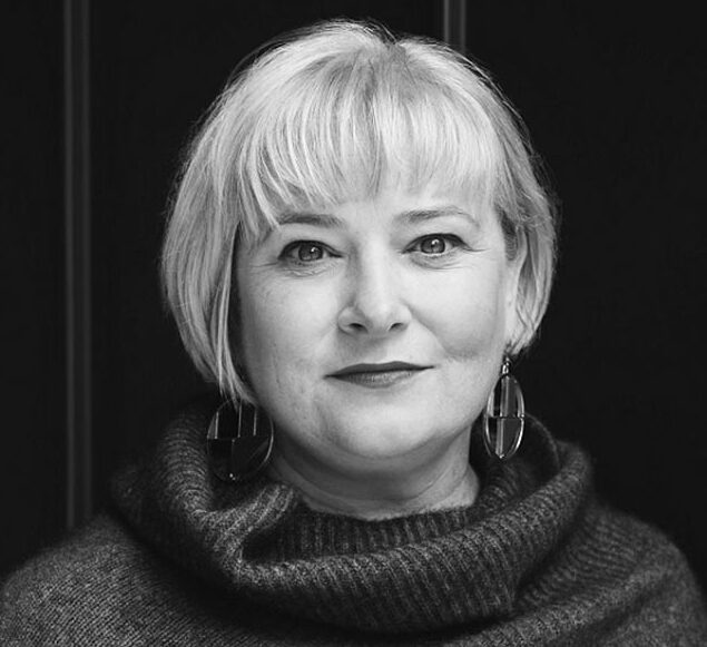 A black and white portrait of Mary Parker smiling into the camera.