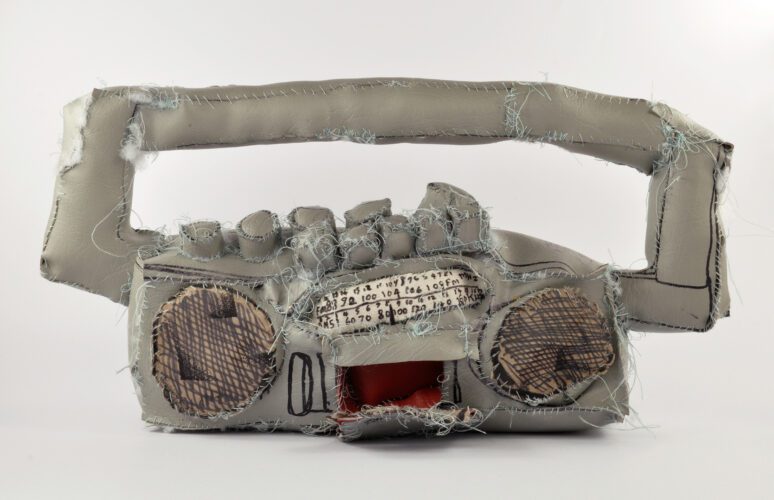 A soft-sculpture made by APA artist Terry Williams depicting a grey boom box.