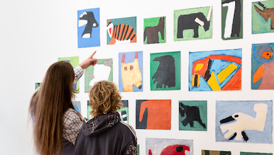 visitors at the Strange Planet exhibition at Arts Project Australia viewing Ruth Howard works